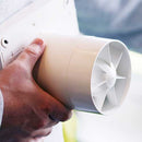 Elta FLUX DMEV 100 ventilation fan for continuous trickle and boost airflow, mounted on a wall in a modern interior setting.