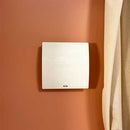 Elta FLUX HR 100 PLUS+ heat recovery unit with remote control, 100mm/4-inch size, mounted on wall in a modern HVAC system