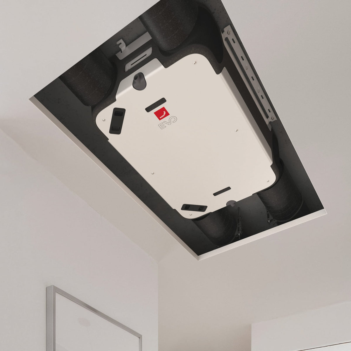 Zehnder EVO 2 compact heat recovery unit installed on ceiling, showcasing its sleek design and ventilation components.